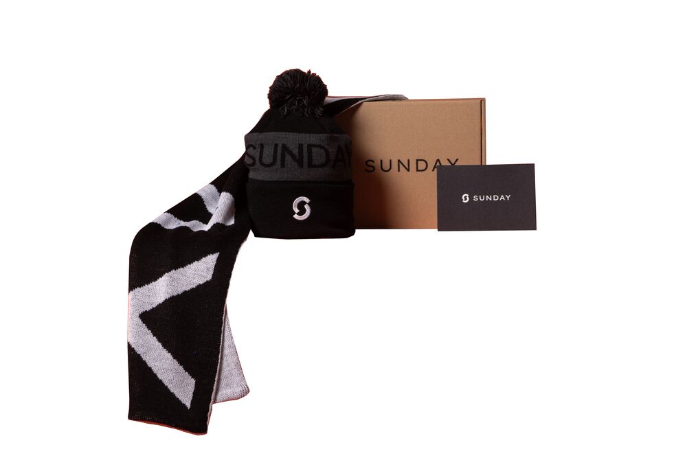 A branded winter gift set with a scarf, beanie, gift box and printed insert card, showing how the card carries the personalised message