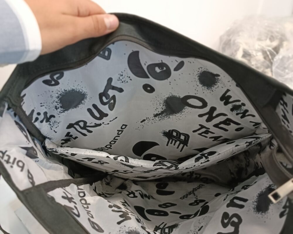 A backpack opened to reveal a custom printed interior lining, showing how brand detail can live inside a product instead of on the outside