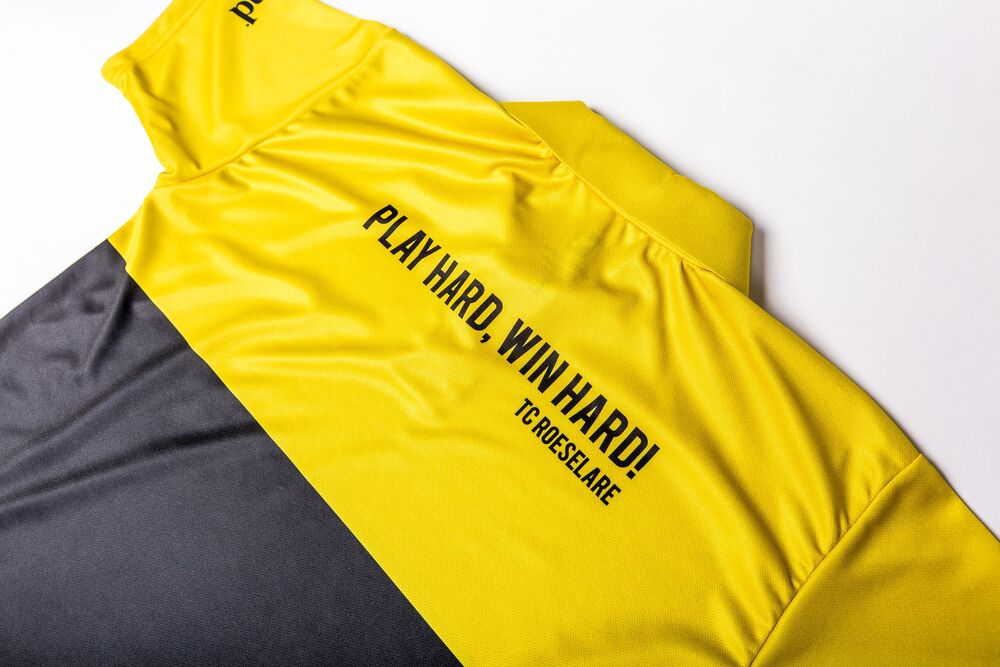 Nahaufnahme eines gebrandeten individuellen Sporttrikots, das die Art von vollflächigem Druck und sauberer Verarbeitung zeigt, nach der ein Unternehmen beim Vergleich von Anbietern für individuelle Sportbekleidung suchen sollte
