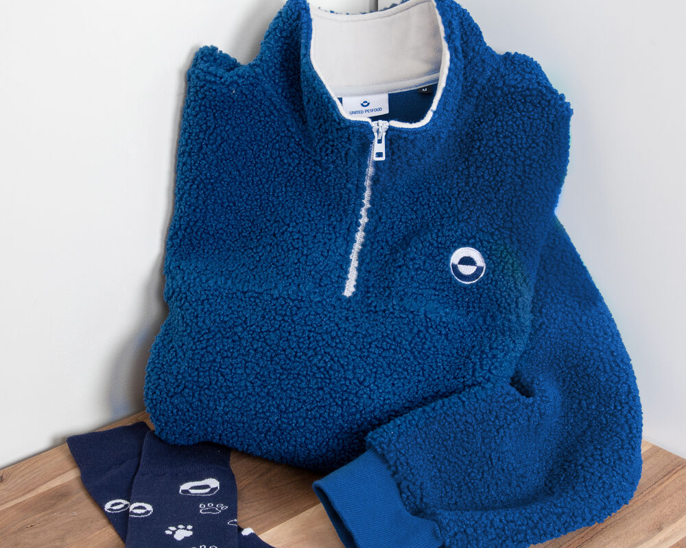 A coordinated corporate gift set of a folded branded fleece and matching socks, an example of what around fifty per recipient buys