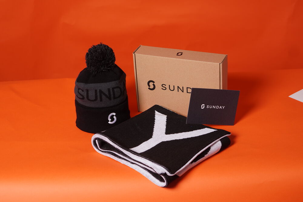 Branded apparel and accessories laid out as an employee gift, showing how wearables and bags work as high-use corporate gifts