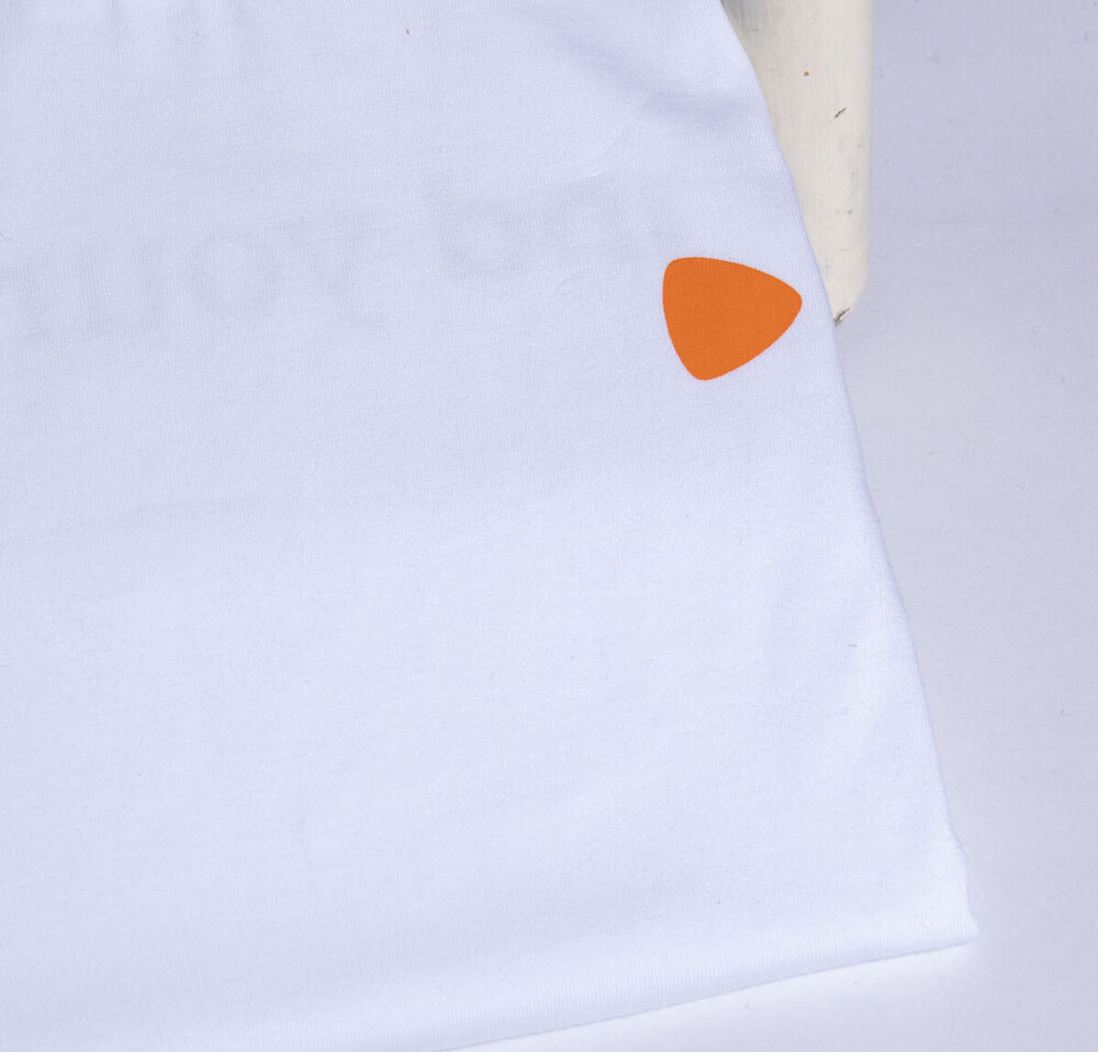 A white branded t-shirt with a small tonal logo detail, an example of the subtle branding that makes corporate gifts more likely to be worn
