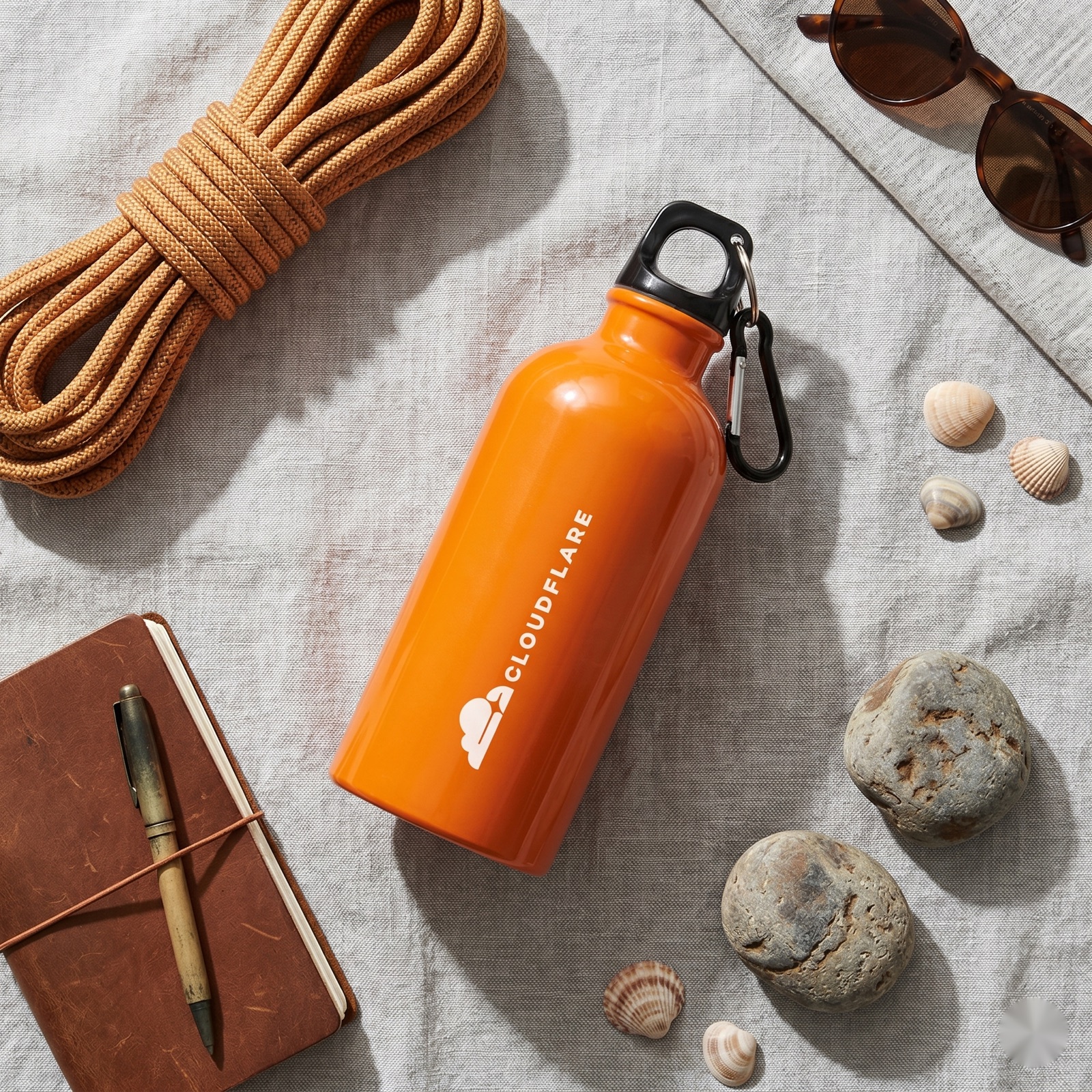 An orange stainless steel custom water bottle outdoors