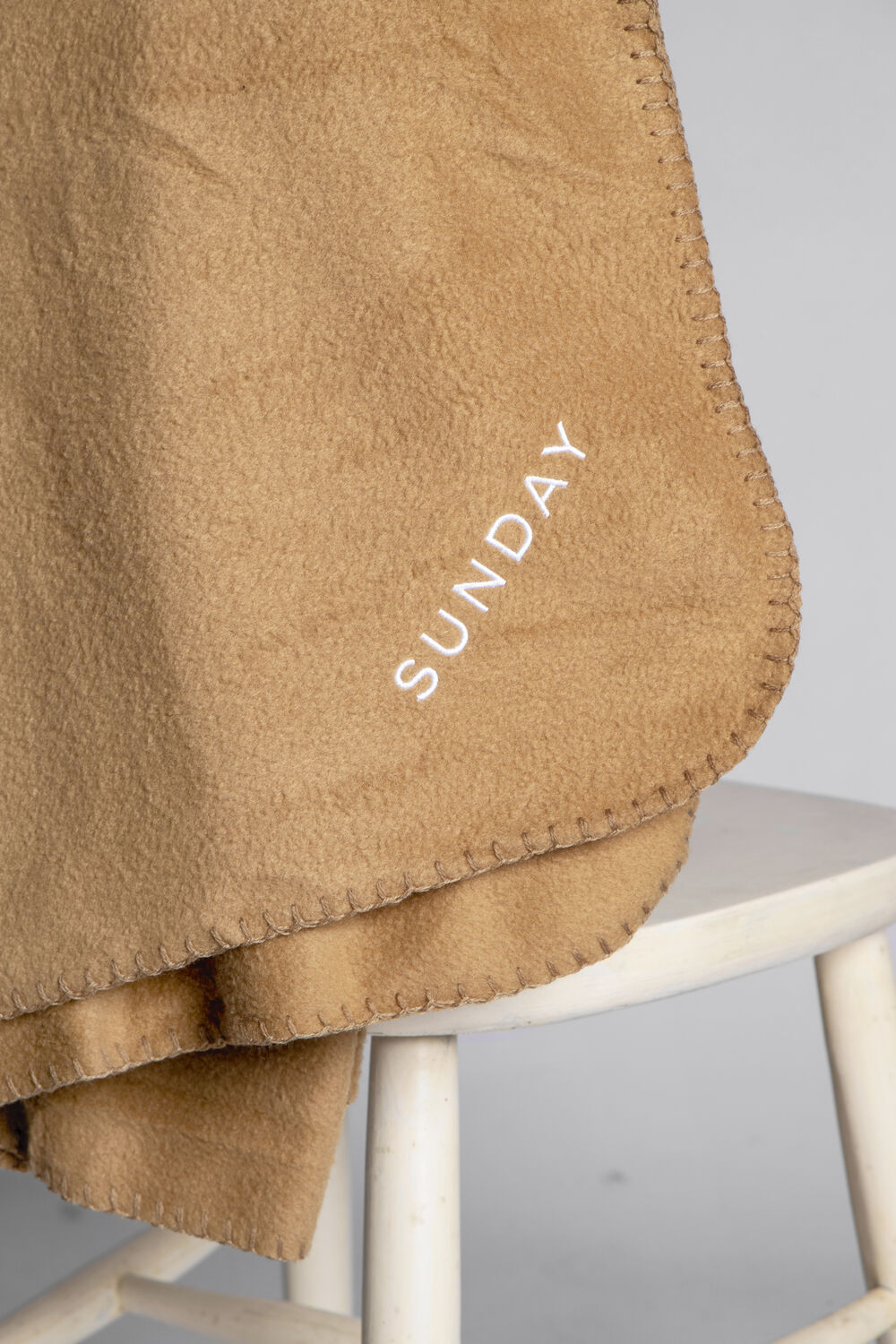 A clean Sunday custom blanket product shot showing the knitted-in design and premium weight
