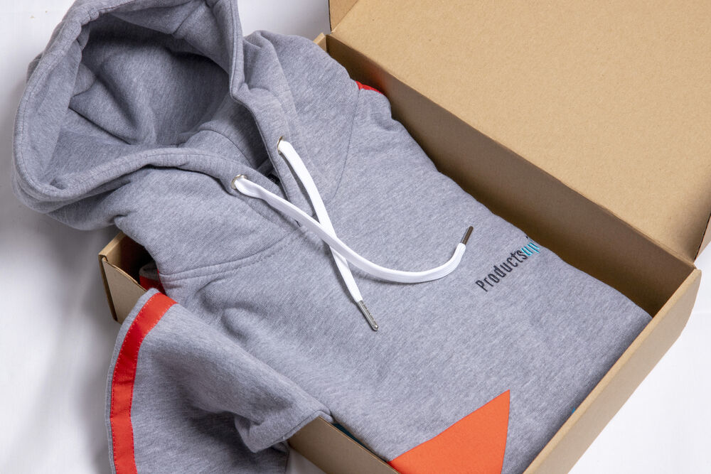 Branded wearable corporate gifts folded and boxed, showing apparel built in the company's own brand