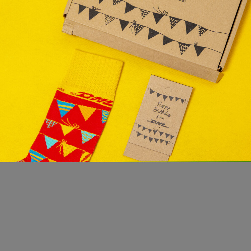 A pair of branded corporate socks presented with a printed box, showing loud branding on the packaging and a subtle mark on the product