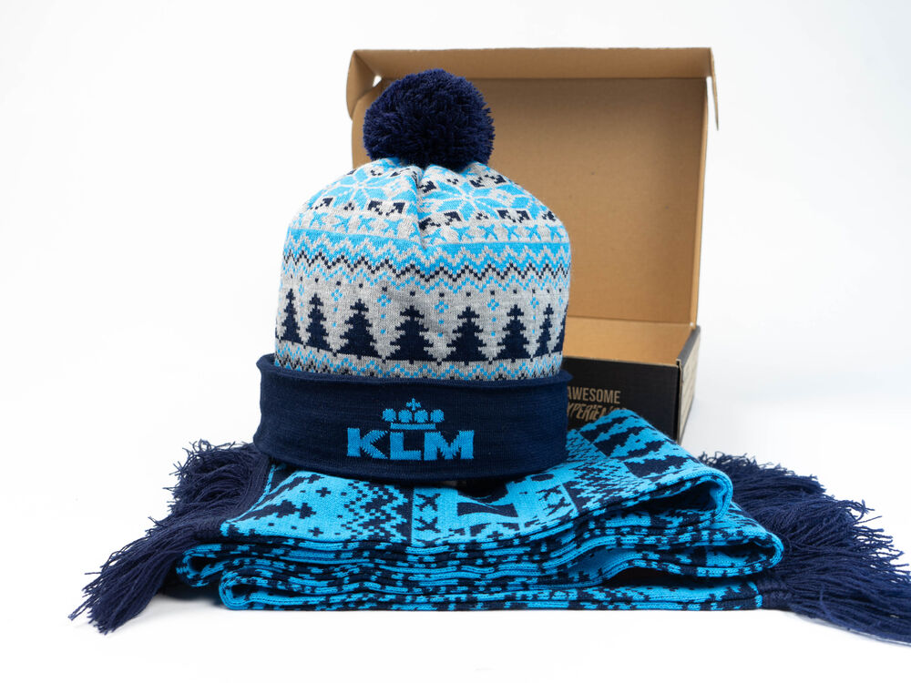 A branded winter gift set with a knitted beanie and matching scarf presented in a kraft gift box, a warm, considered employee gift