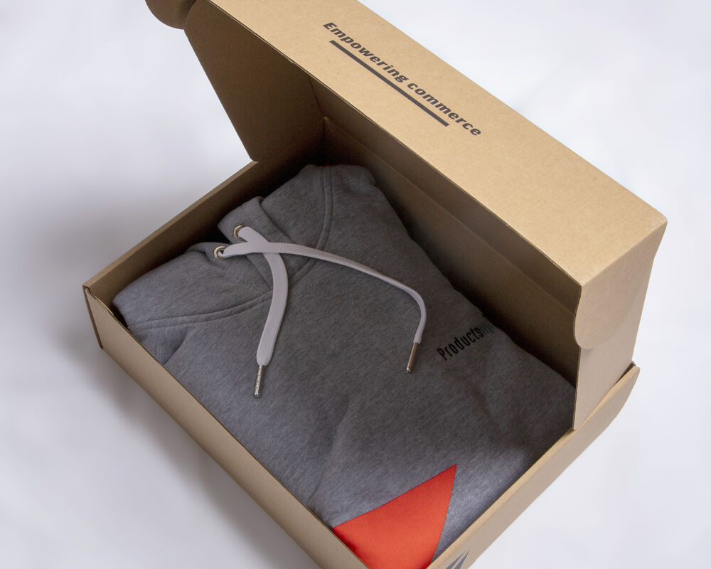 A branded hoodie folded inside a printed gift box, an example of employee-facing apparel where clear branding is welcome