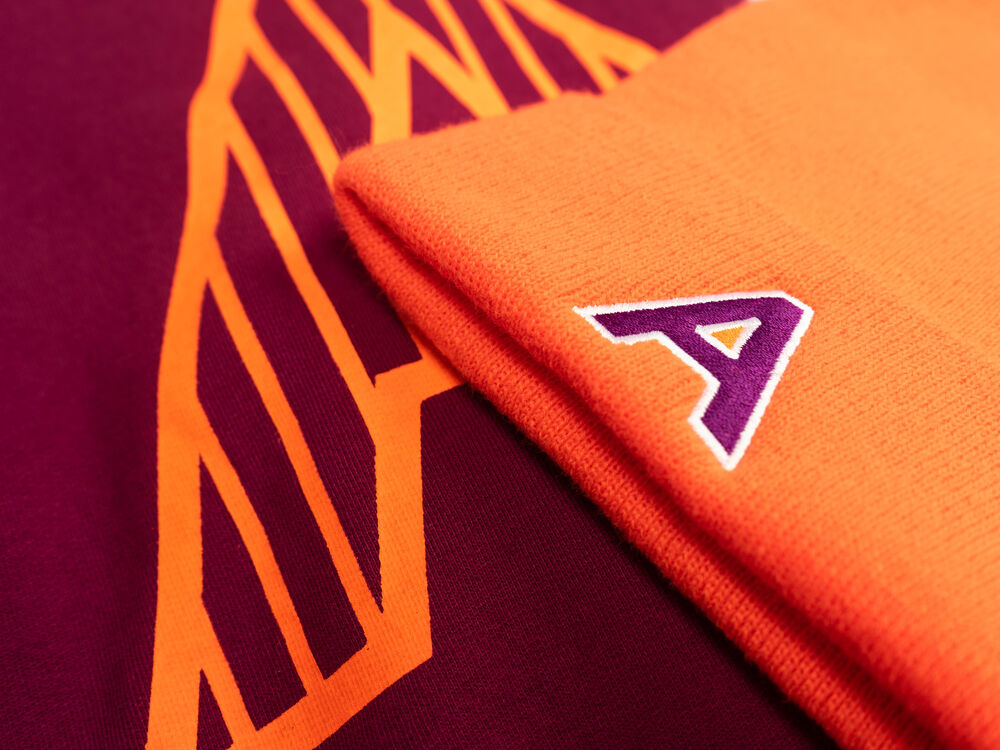 A close-up of a company logo printed on a folded tee, showing tasteful, well-scaled branding on an existing garment