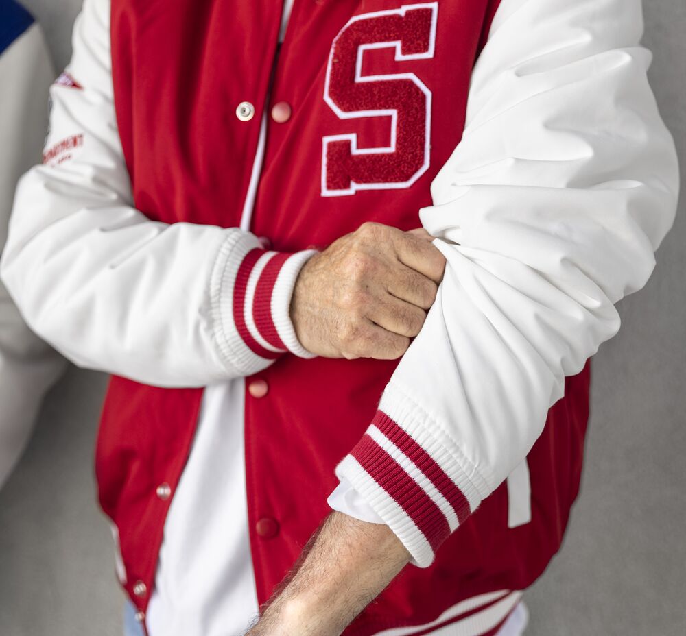 A custom branded varsity jacket, where material choice and durability decide its real footprint