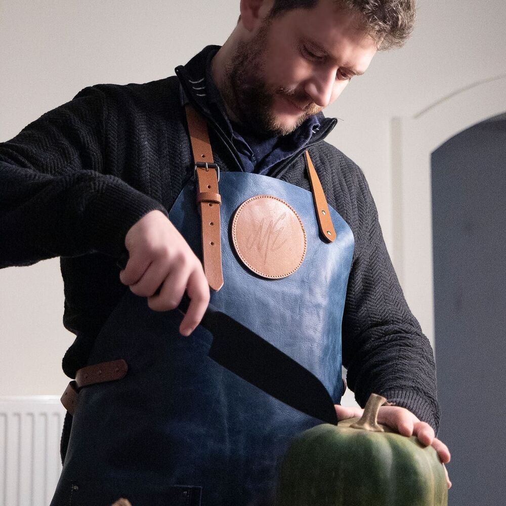 A premium leather custom apron, an example of a high-value finish that turns the apron into a gift rather than a uniform