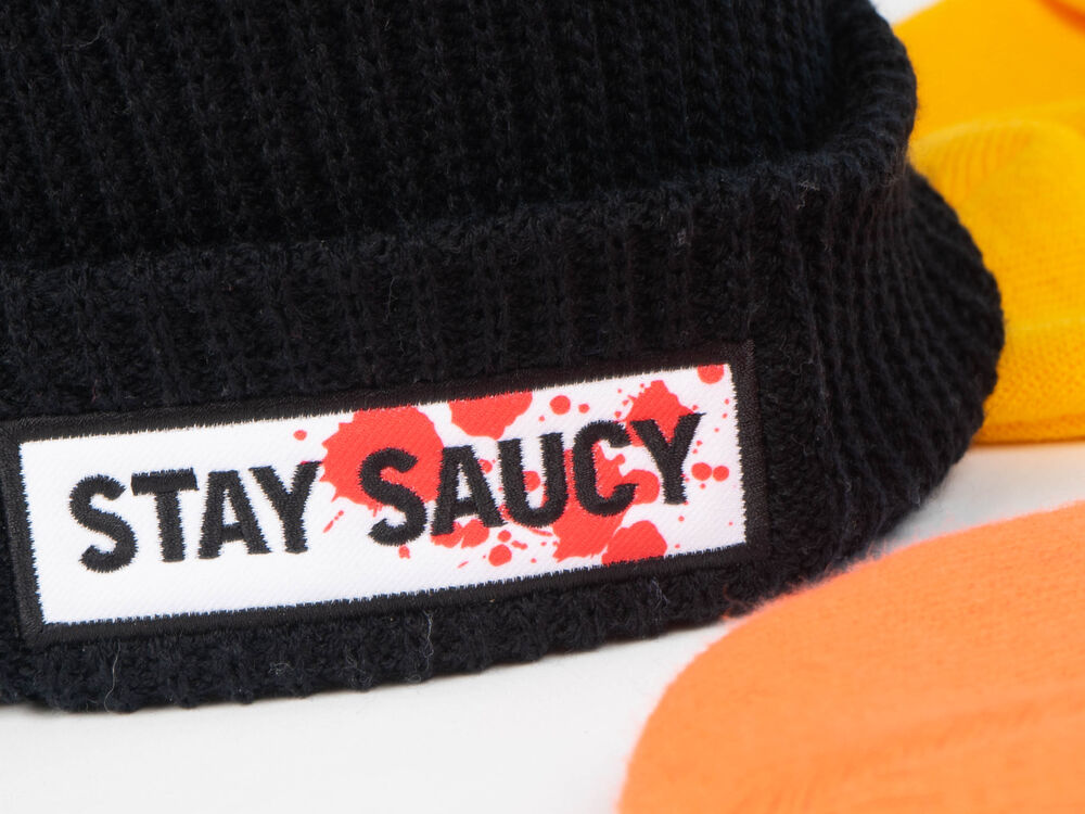 A team wearing matching branded beanies at a winter team-building event