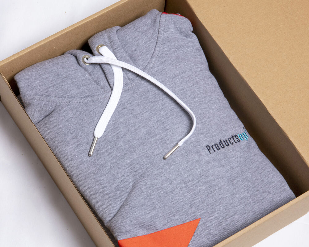 An open branded gift box with a folded hoodie inside, showing what a corporate gift under $50 looks like when packaging is done properly