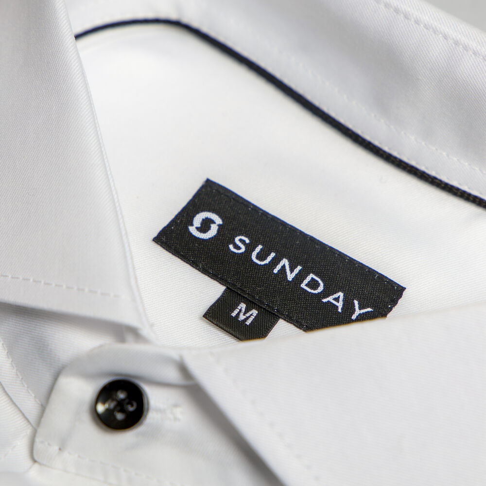 A sewn woven brand label on a garment, a premium decoration alternative to printing on a polo