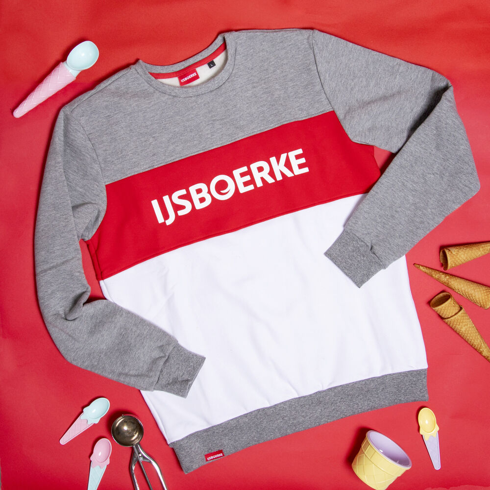 Corporate clothing example with a retro touch: a sweater with color blocks and brand typography from the brand's visual heritage