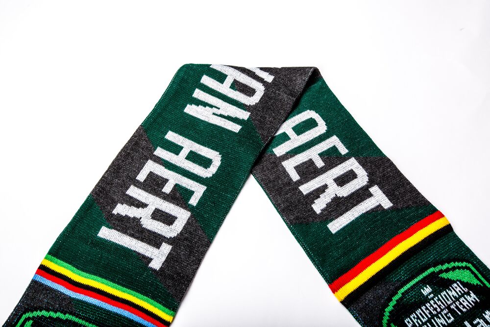 A branded knit beanie shown in use, where decoration must survive stretching and wear
